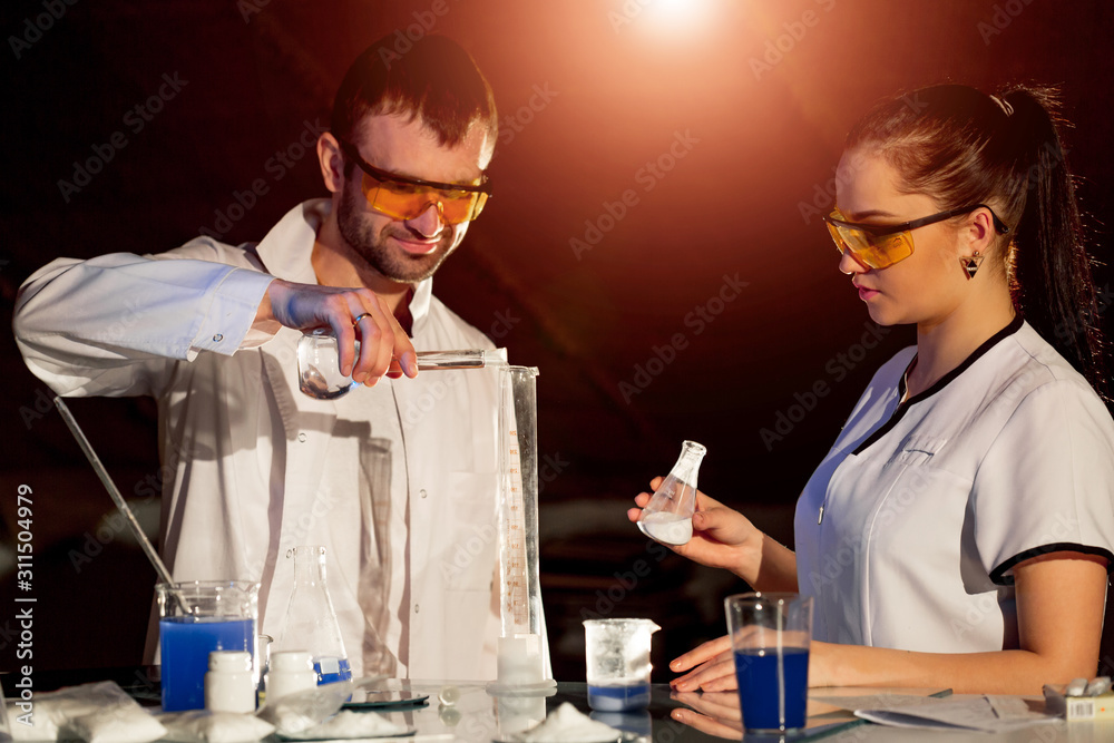 Researchers men and woman working with lab glassware pharmaceutical industry in science laboratory r
