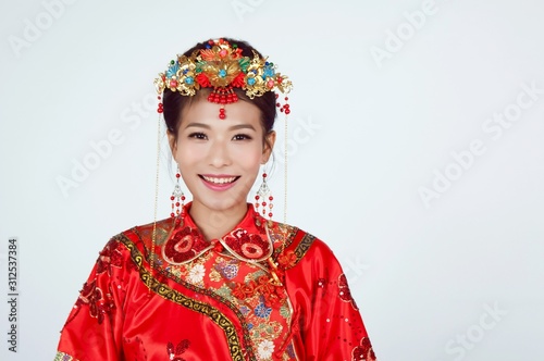 Portrait of young attractive chinese bride wearing traditional costume
