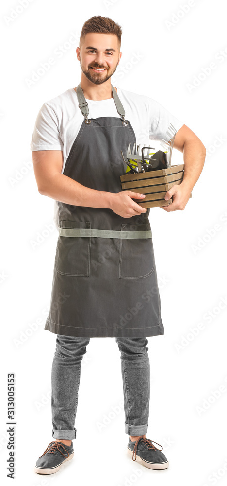 Handsome male gardener with tools on white background