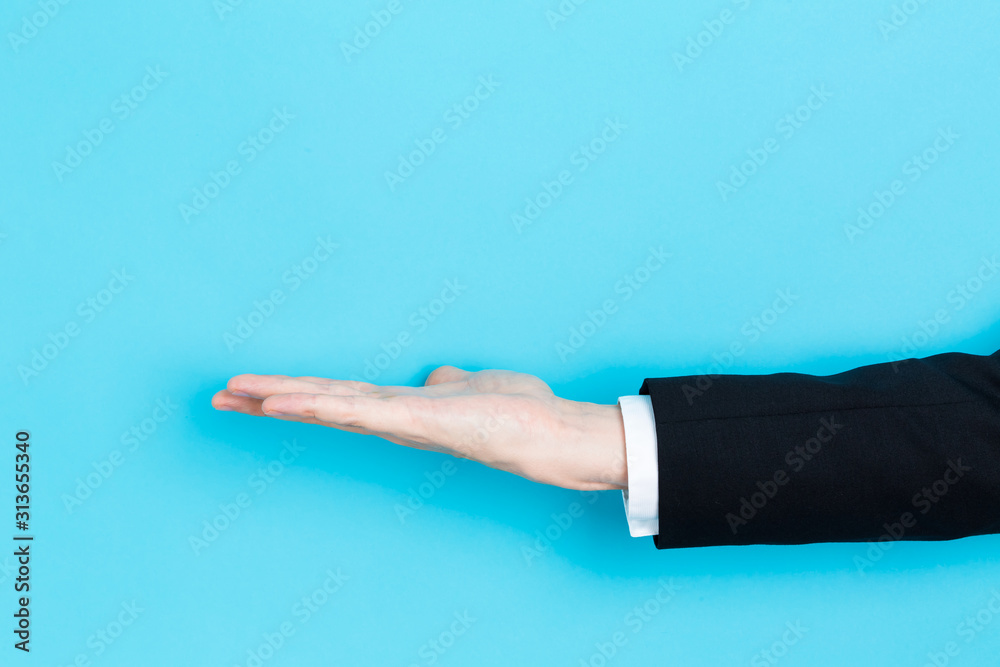 Businessman presenting something in his hand on a blue background