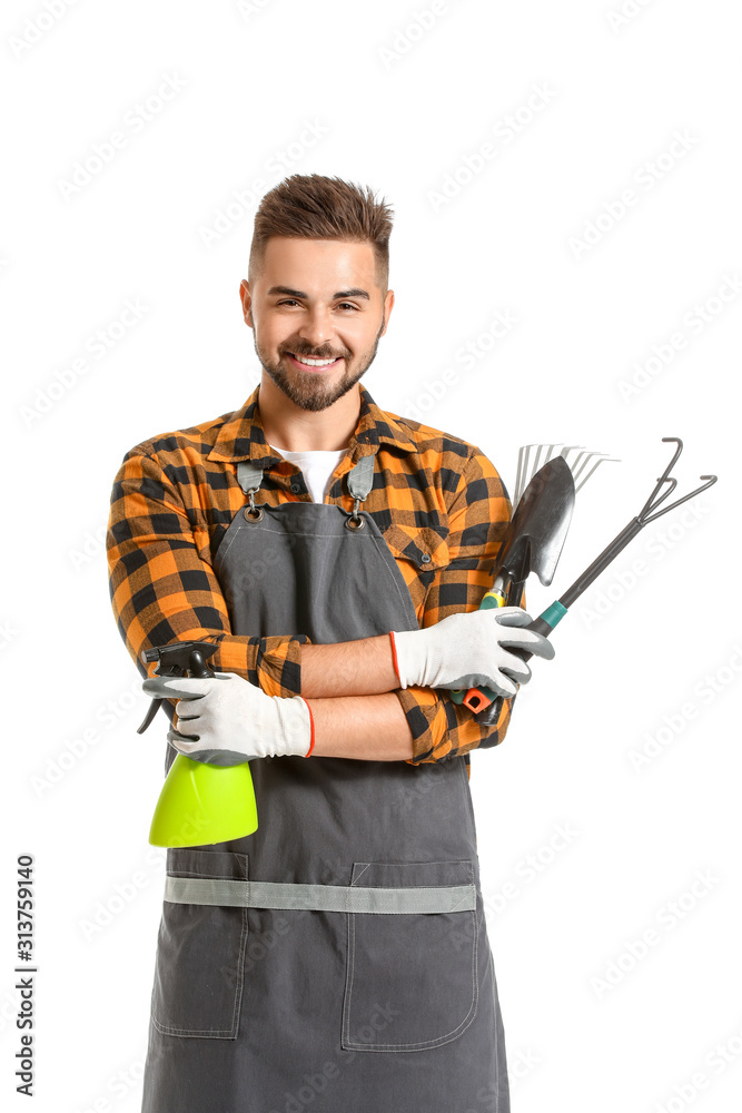 Handsome male gardener with tools on white background
