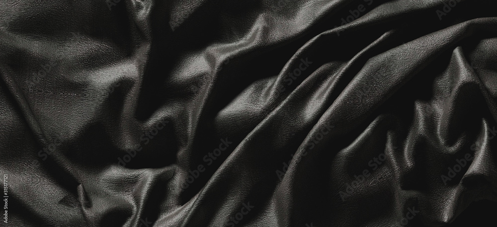 Abstract dark wrinkle fabric.Canvas texture detail in the dark.Smooth elegant dark leather or satin 