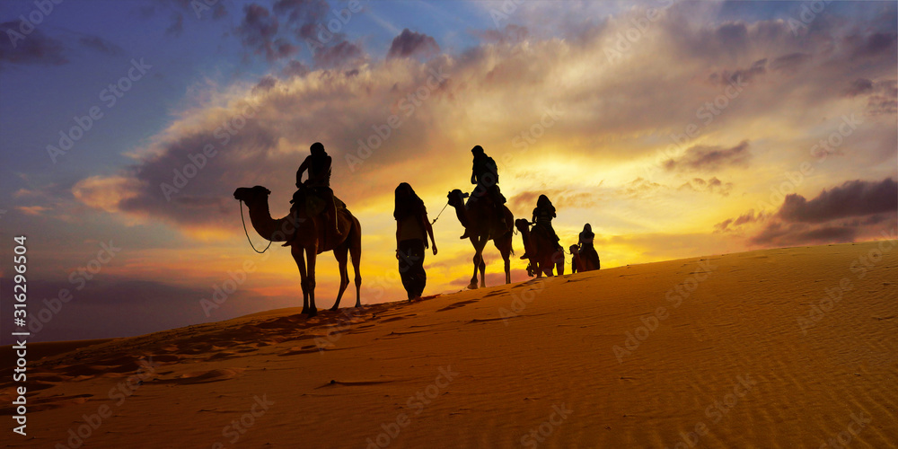 日落时分摩洛哥撒哈拉沙漠中的骆驼大篷车