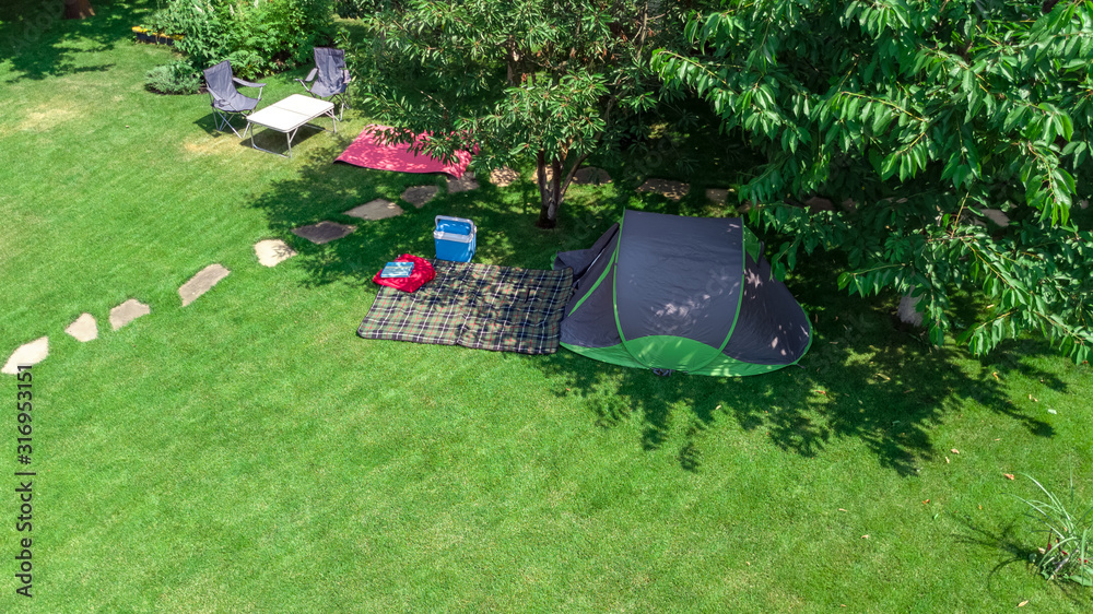 露营地俯视图，树下的帐篷和露营设备，家庭度假