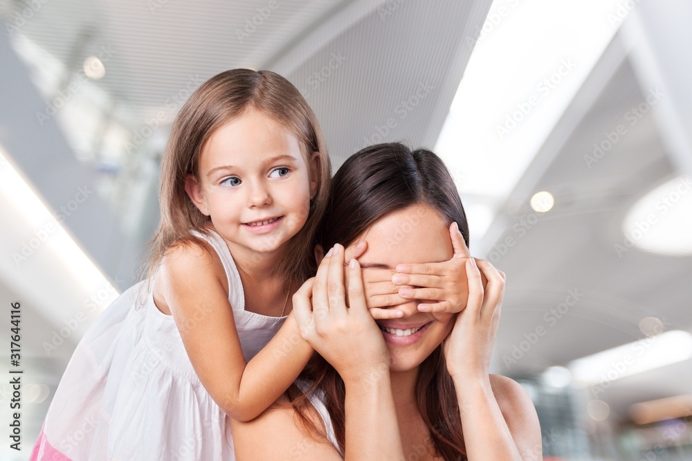 Portrait of happy daughter close motherâ€™s eyes