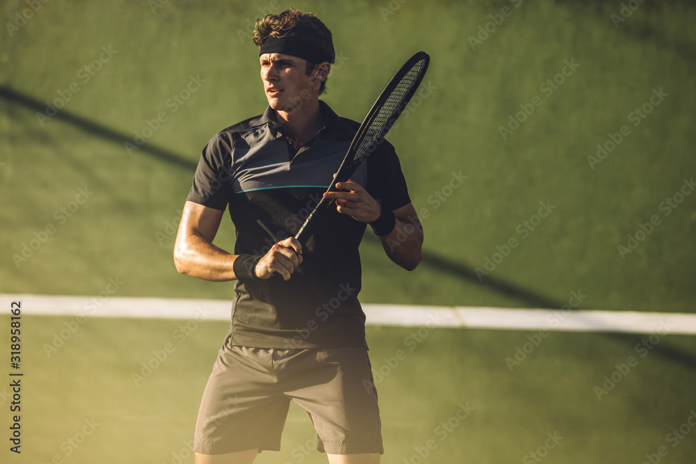 在硬地球场上拿球拍的职业网球运动员