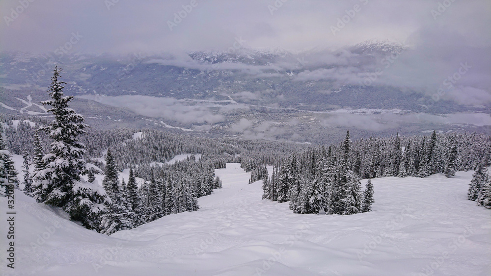 Panoramic view of snowy valley and mountains in remote part of British Columbia.