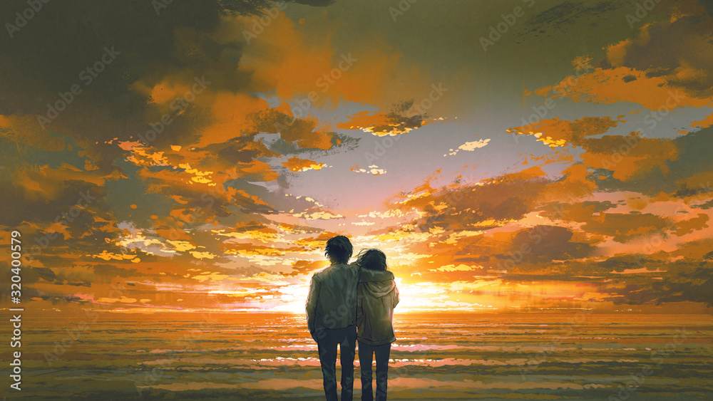 年轻夫妇看日落海滩