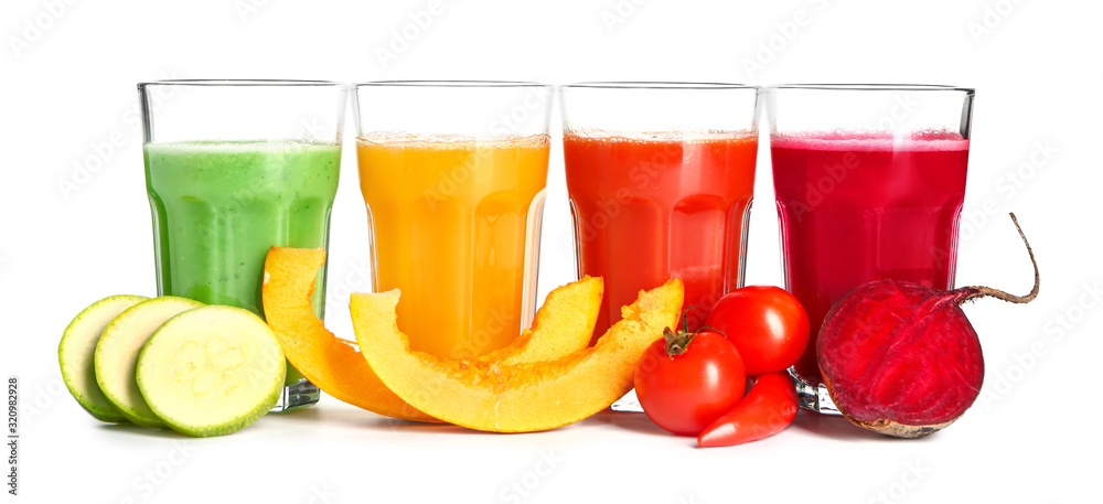 Glasses of fresh vegetable juices on white background