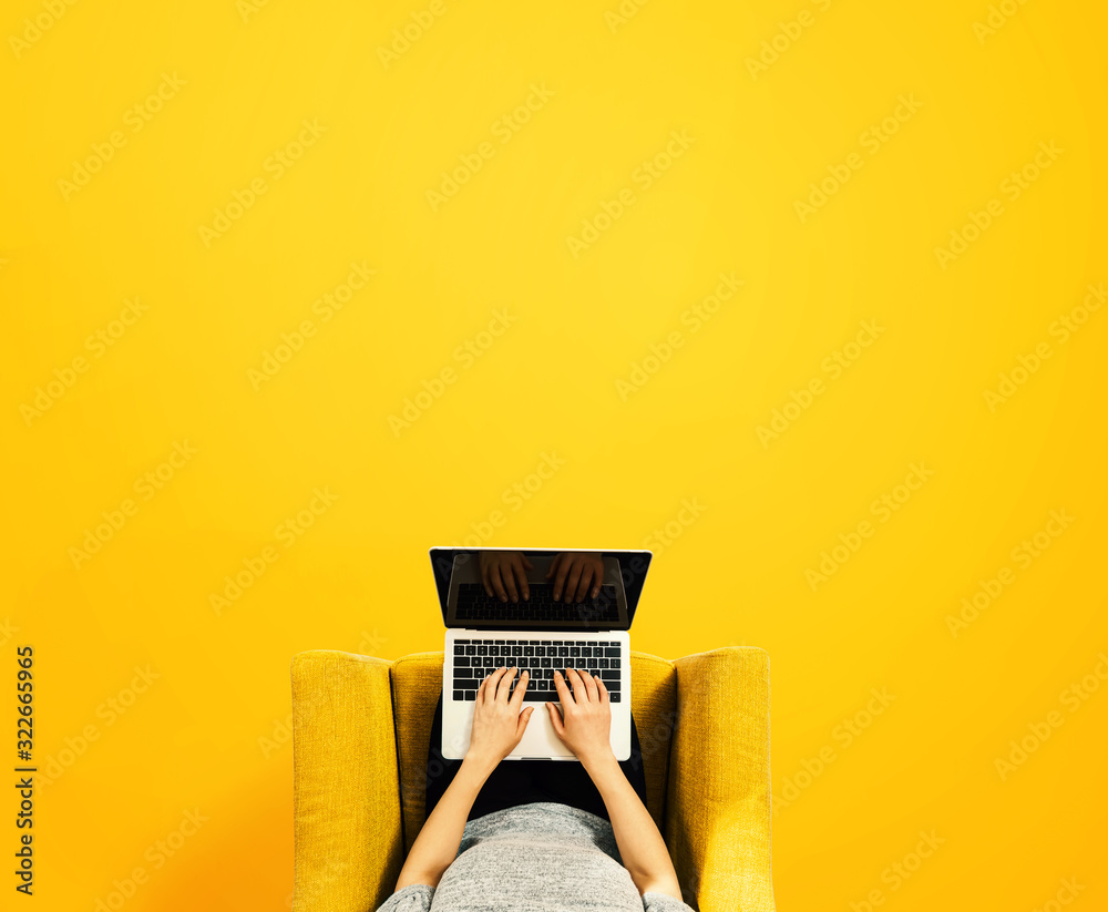 Woman using a laptop computer overhead view