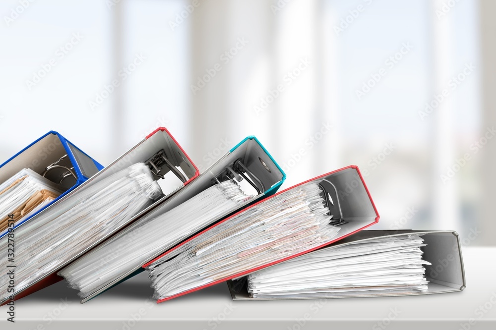 File folders with paper documents on the desk