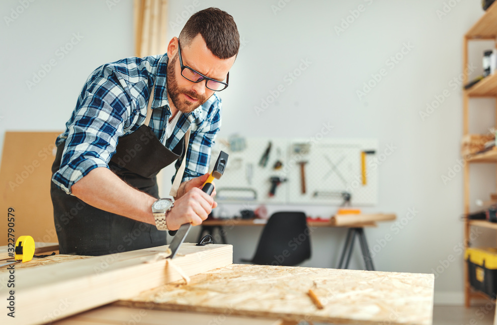 young male carpenter working in  workshop.