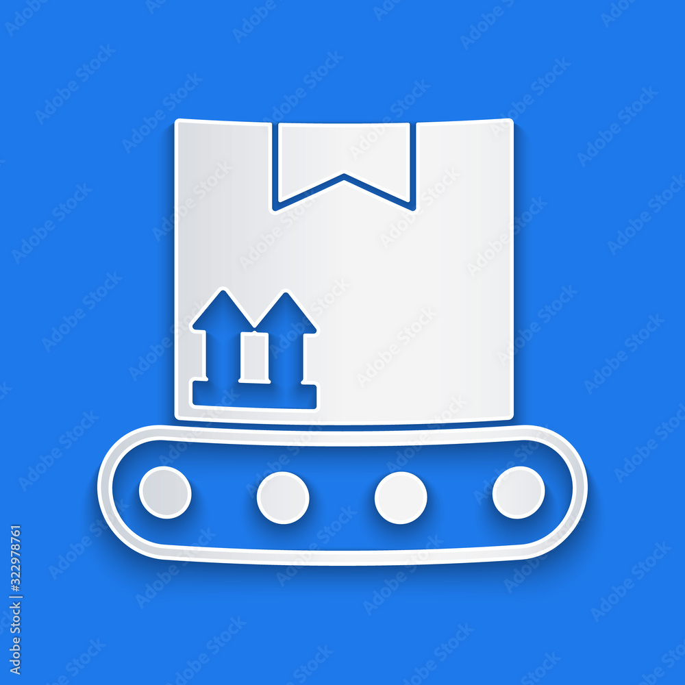 Paper cut Conveyor belt with cardboard box icon isolated on blue background. Paper art style. Vector