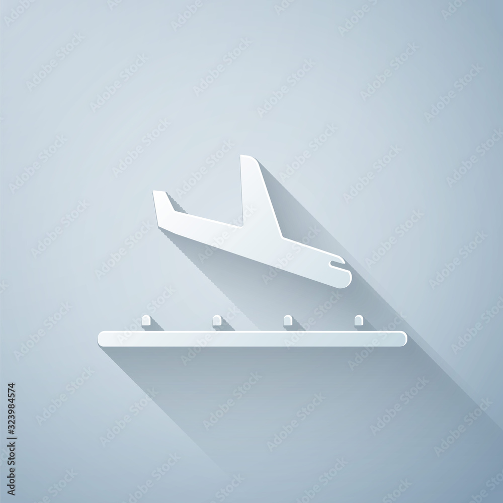 Paper cut Plane landing icon isolated on grey background. Airplane transport symbol. Paper art style