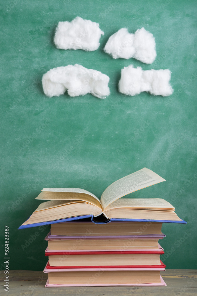 Education and reading creative concept - open under the cotton clouds book, inspiration for a fairy 