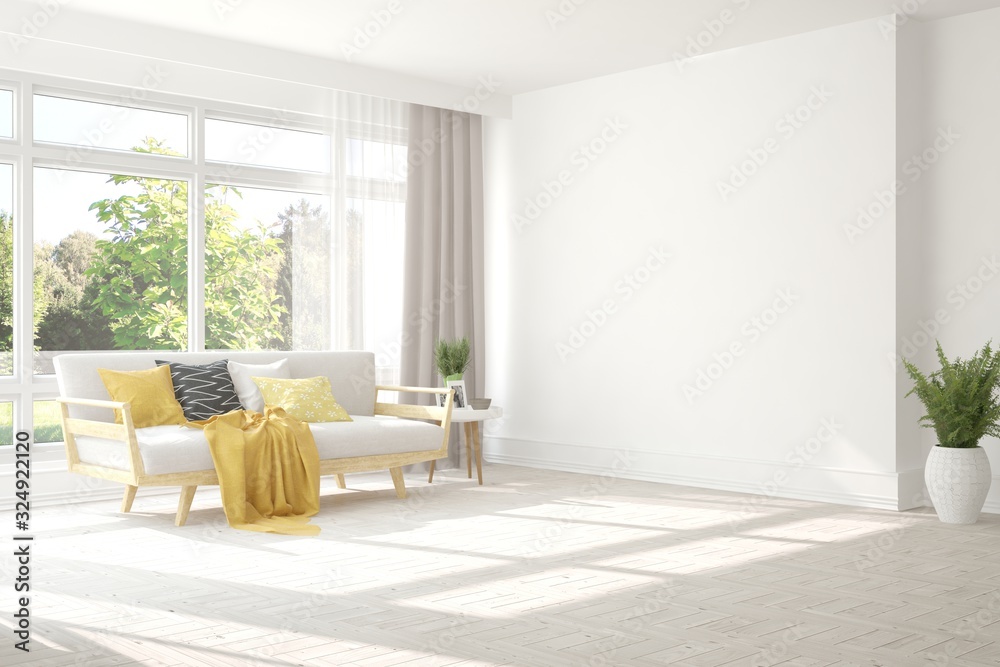 Minimalist living room in white color with sofa and summer landscape in window. Scandinavian interio