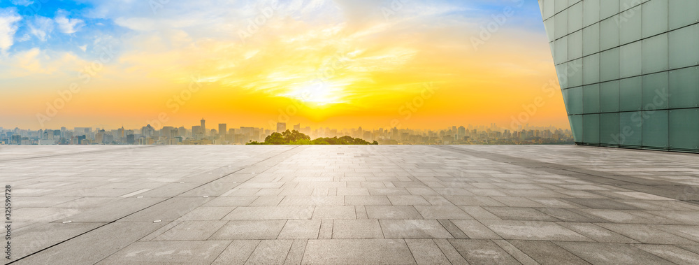 Wide square floor and city skyline at sunrise in Hangzhou,China.