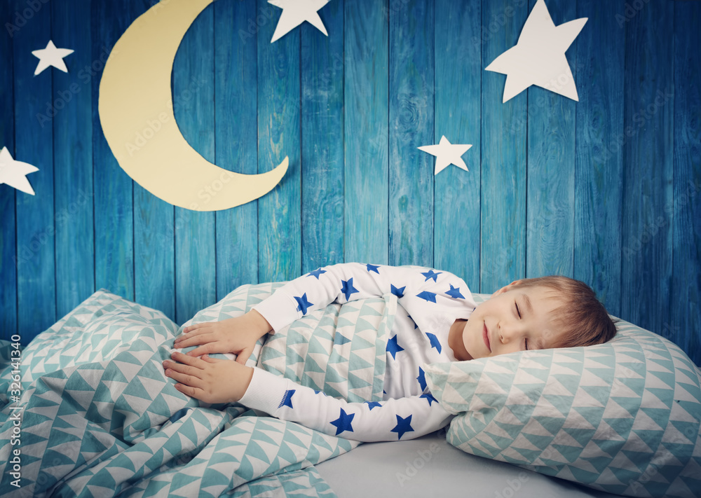 Five years old child sleeping in bed