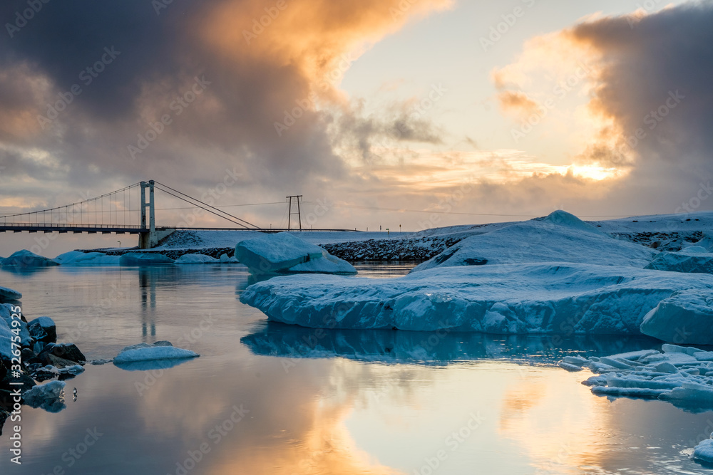 Iceland: bridge, iceberg and sunset in the Glacier Lagoon