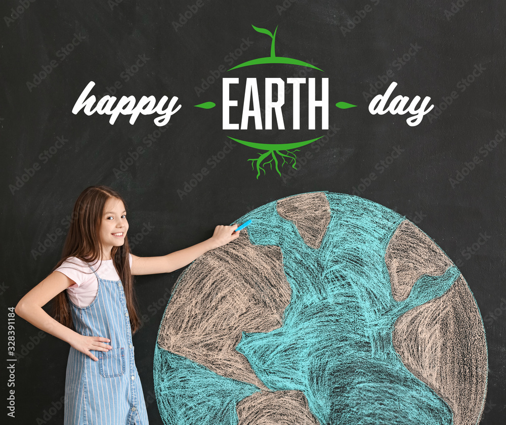 Little girl drawing planet on dark background. Earth Day celebration
