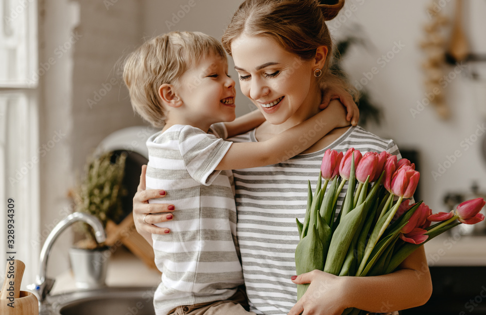 happy mothers day! child son gives flowers for  mother on holiday