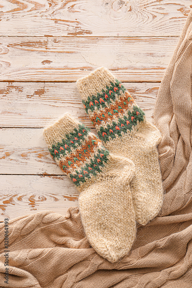 Knitted socks on wooden background