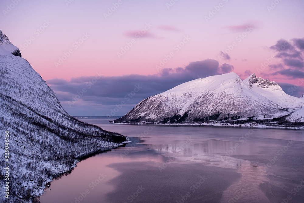 Mountains and sky during sunset. Senja island, Norway. Clouds on the sky during sundown. Nature back