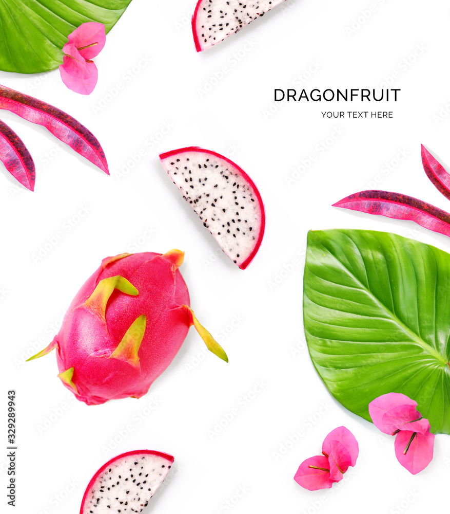由火龙果和热带树叶在白色背景上制成的创意布局。平面布局。食物概念。