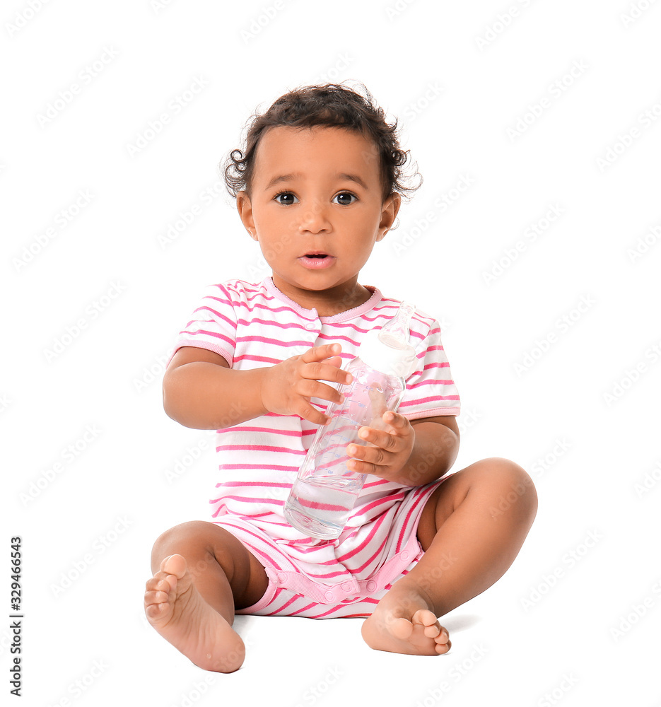 Cute African-American baby with bottle of water on white background