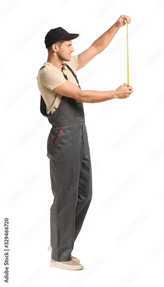 Handsome male worker with measuring tape on white background