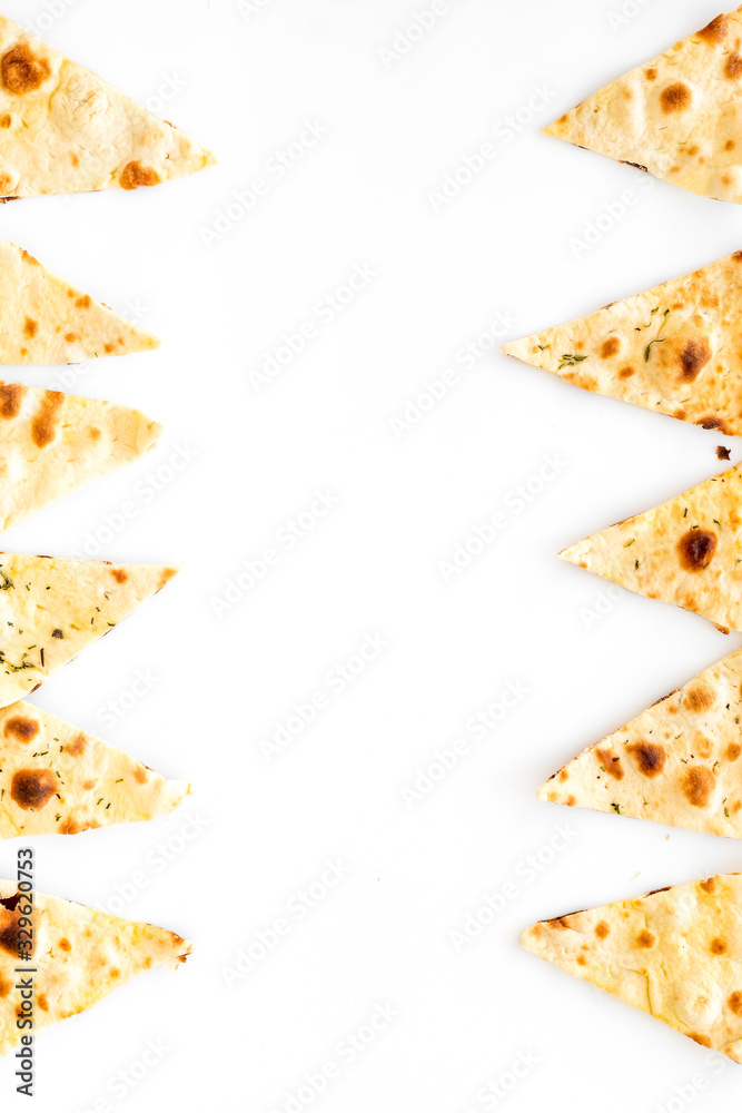 Focaccia pieces frame on white background top-down copy space