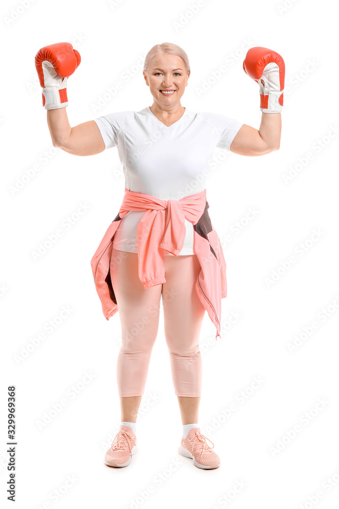 Sporty mature female boxer on white background