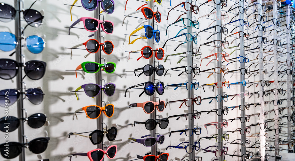 Exhibitor of glasses consisting of shelves of fashionable glasses shown on a wall at the optical sho