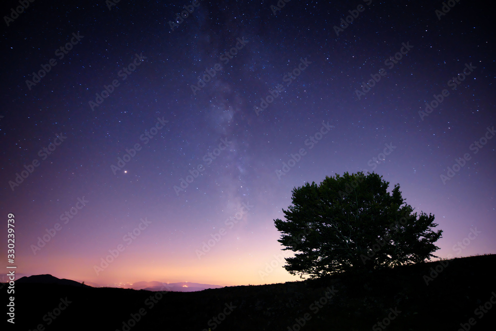 Galaxy and stars above the hillside; beautiful night scene