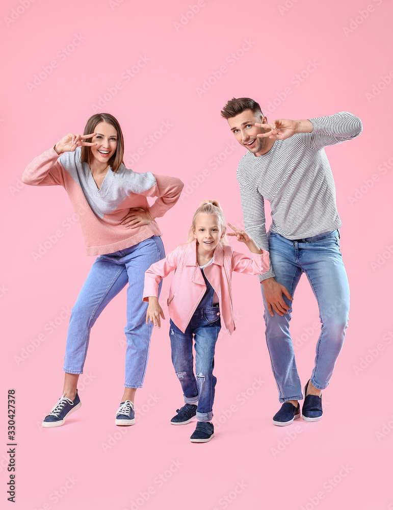 Happy family dancing against color background
