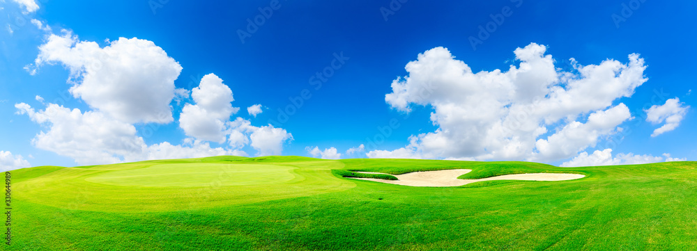 Green golf course and blue sky with white clouds,panoramic view.