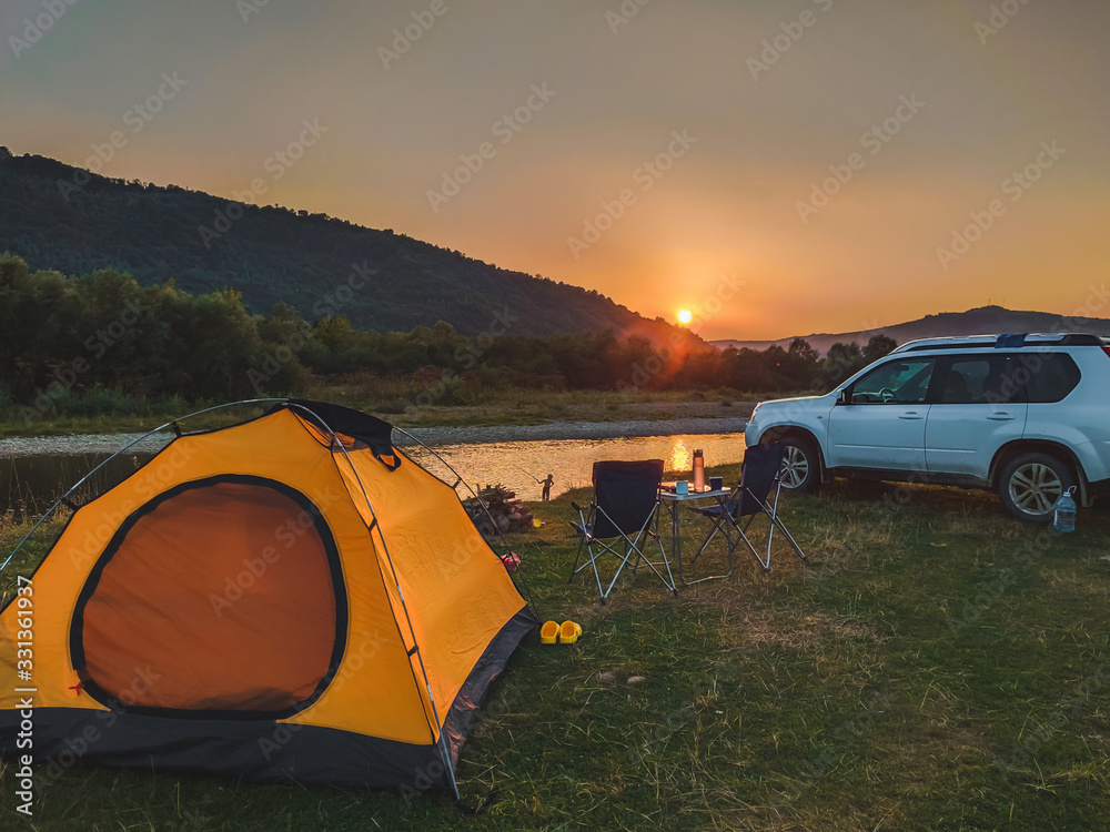 car travel concept camping place near mountains river
