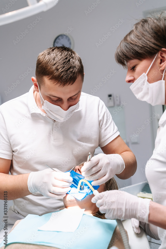 Dentists are working in modern stomatology clinic. Stomatological instrument in the dentist clinic. 