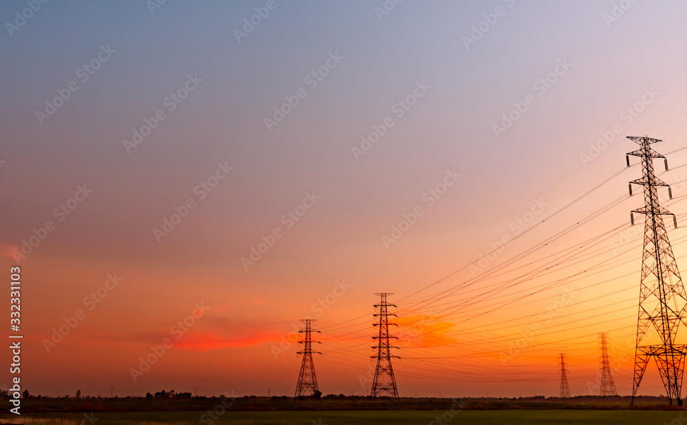 High voltage electric pylon and electrical wire with sunset sky. Electricity poles. Power and energy