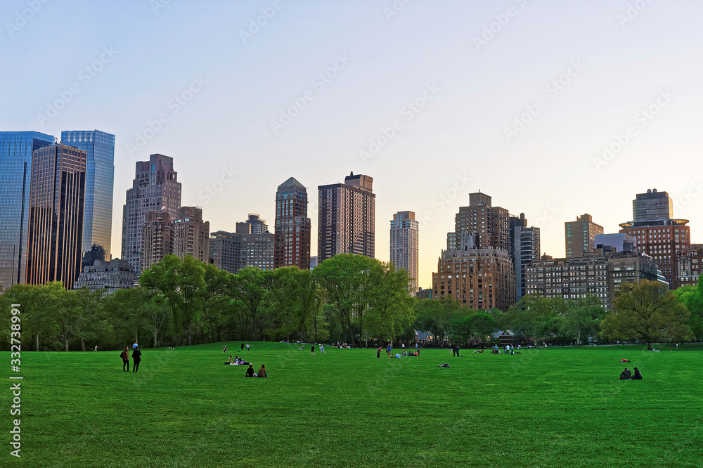 Manhattan skyline and green lawn in Central Park West
