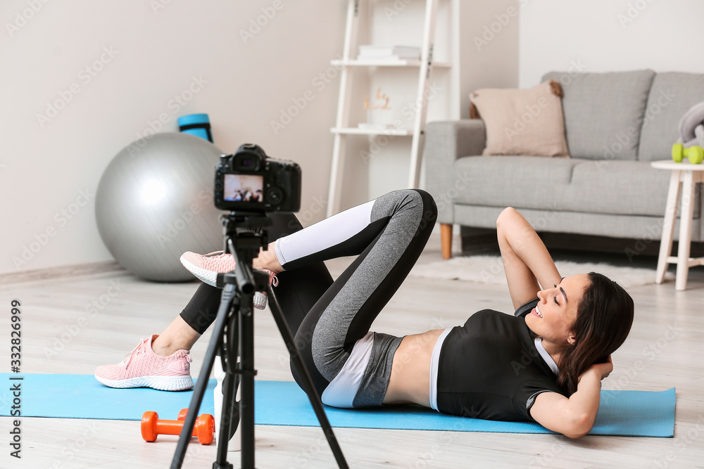 Female blogger recording sports video at home