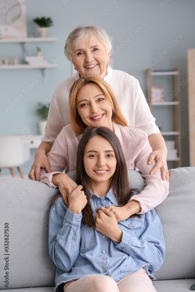 Mature woman with her adult daughter and mother spending time together at home