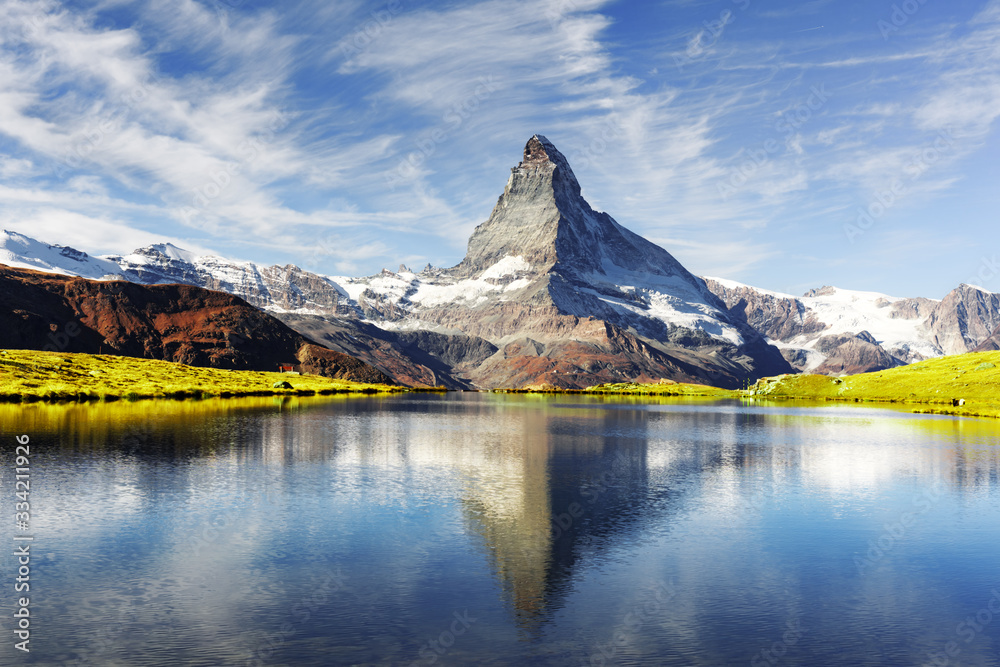 Picturesque view of Matterhorn Cervino peak and Stellisee lake in Swiss Alps. Day photo with blue sk