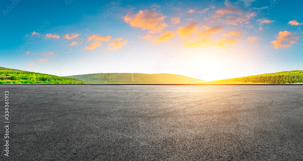 Race track road and green tea plantation nature landscape at sunset.