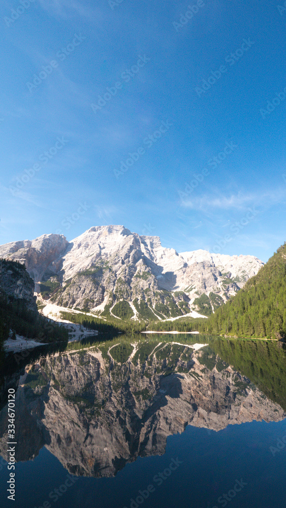 Landscape of beautiful summer, snowcapped mountains and blue sky reflecting on the lake