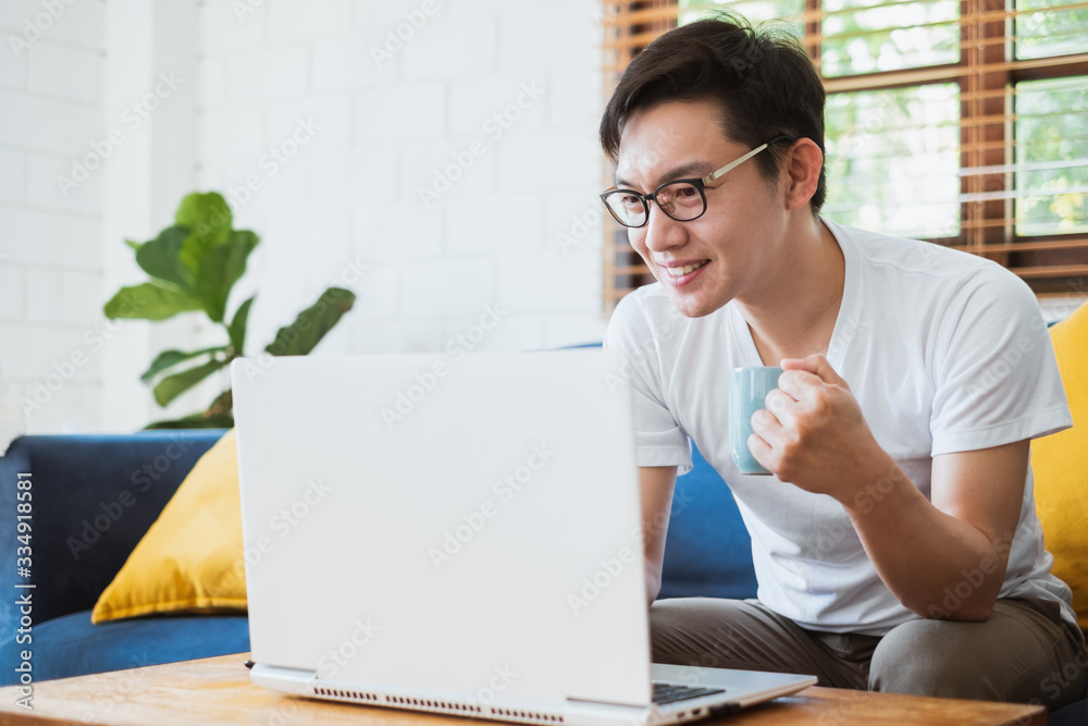 Work from home or work at home concept, asian man working with laptop computer due to quarantine fro