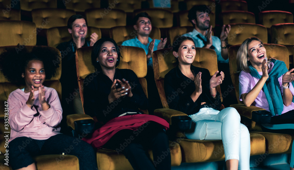 People audience watching movie in the movie theater cinema. Group recreation activity and entertainm