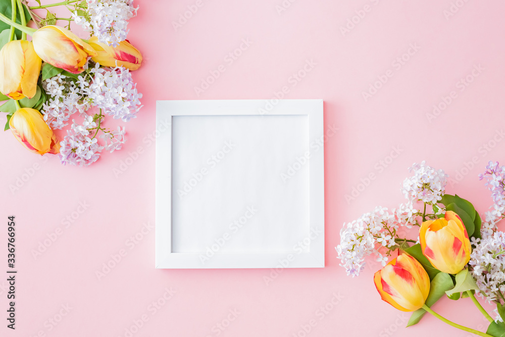Mockup square frame with branches of lilac and yellow tulips on a pink background