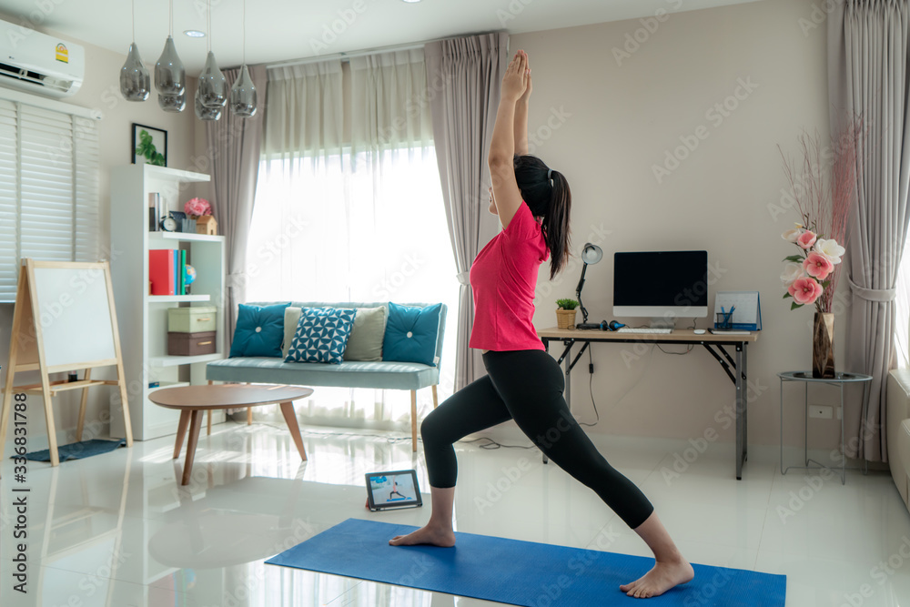 Asian woman making yoga exercise for step away from their computers to take mid-day exercise breaks 