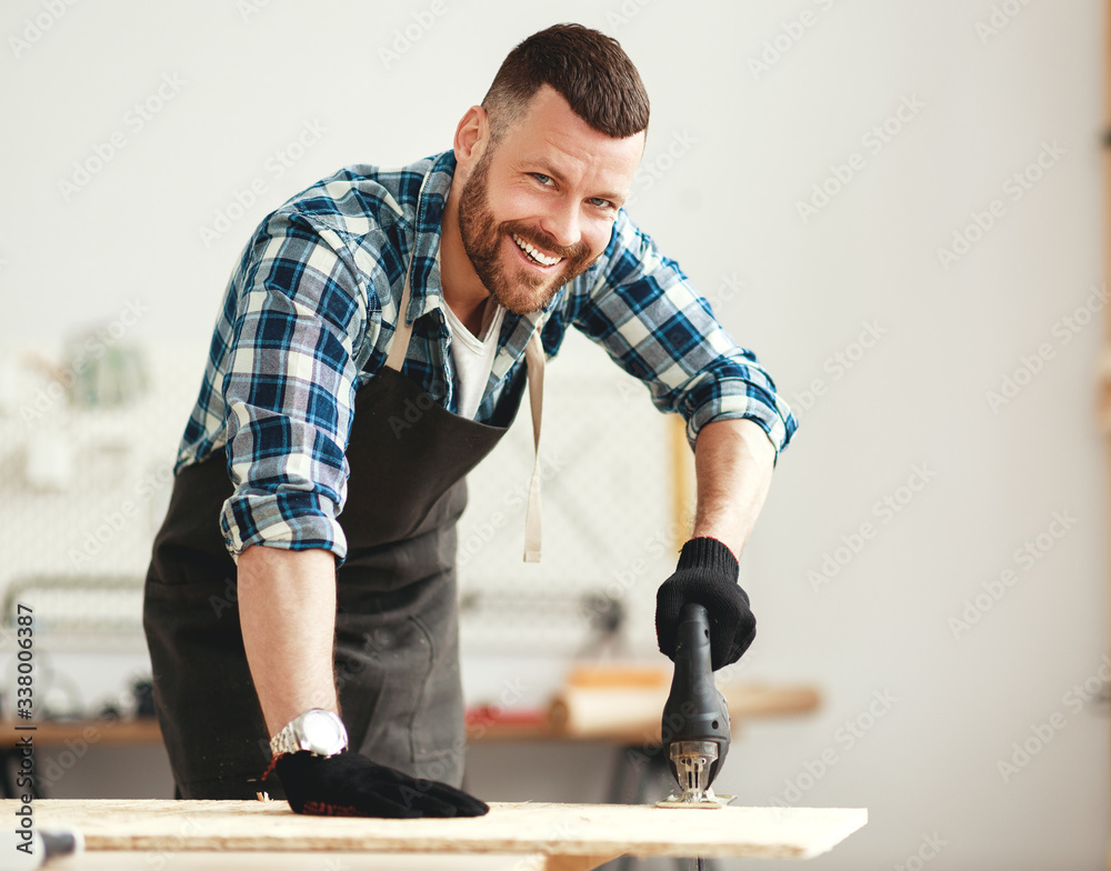 young male carpenter working in  workshop